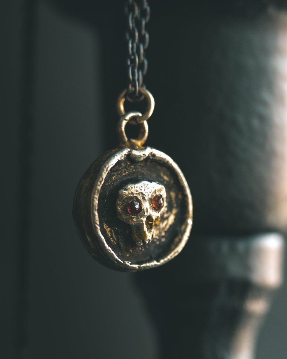 Memento Mori Skull Charm with Almandine Garnet Eyes Sterling Silver & 23.5K Gold | Talisman of Life, Death, and Deep Transformation - Machinations