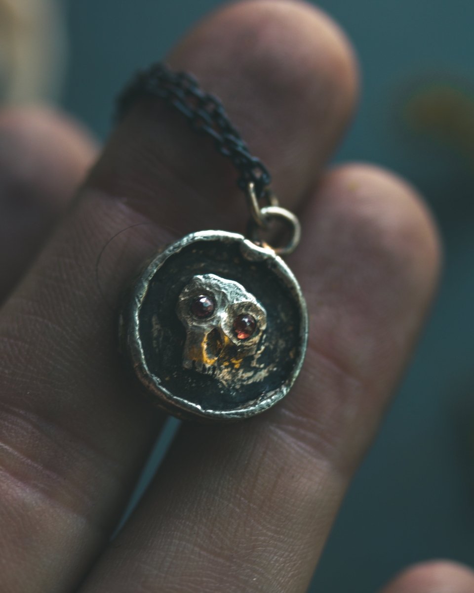 Memento Mori Skull Charm with Almandine Garnet Eyes Sterling Silver & 23.5K Gold | Talisman of Life, Death, and Deep Transformation - Machinations