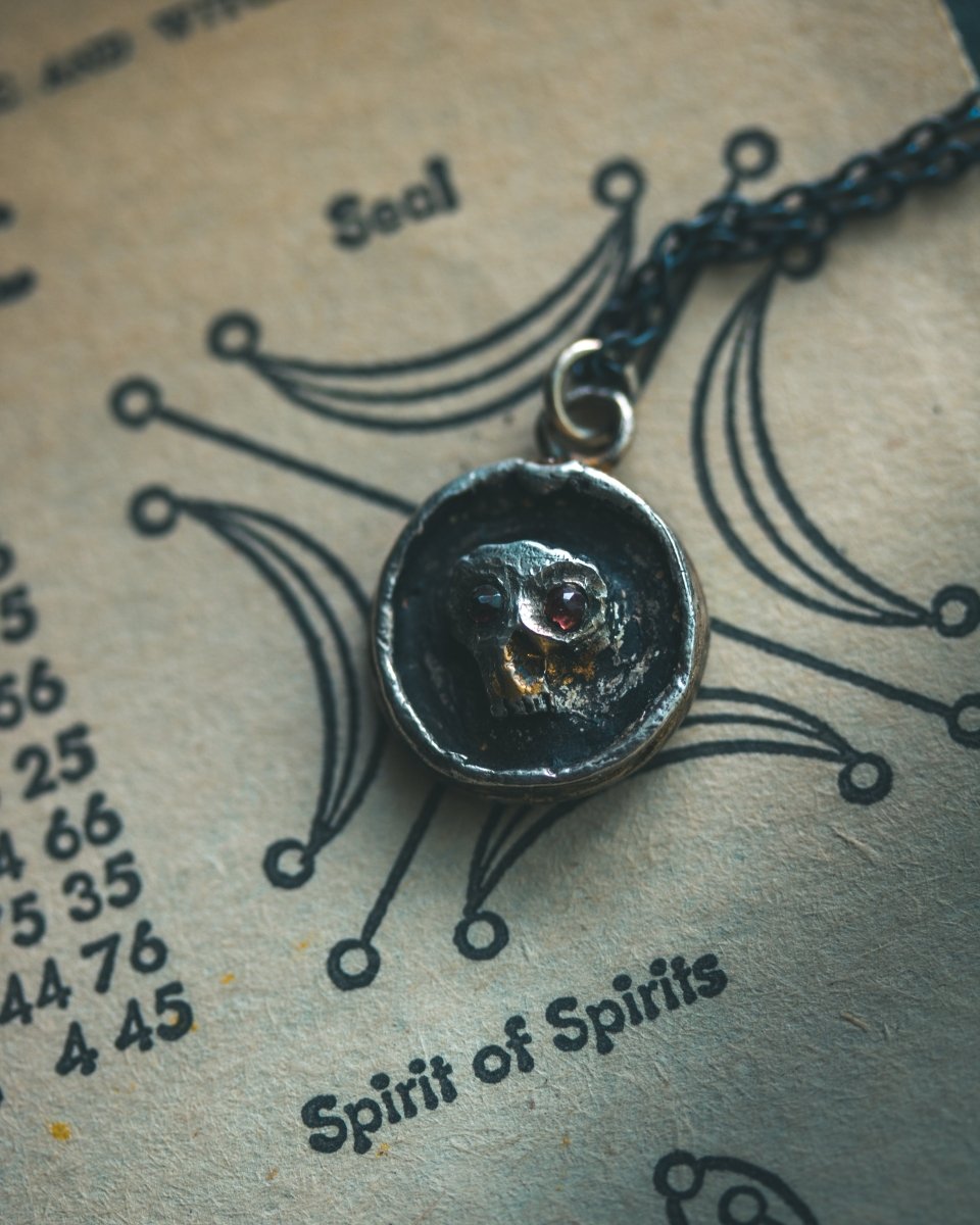 Memento Mori Skull Charm with Almandine Garnet Eyes Sterling Silver & 23.5K Gold | Talisman of Life, Death, and Deep Transformation - Machinations