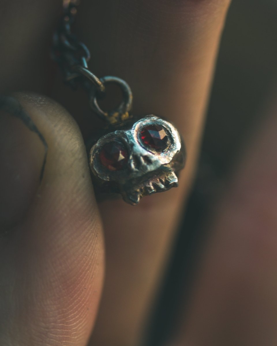 Memento Mori Skull Charm with Almandine Garnet Eyes – Sterling Silver & 23.5K Gold | Talisman of Life, Death, and Deep Transformation - Machinations