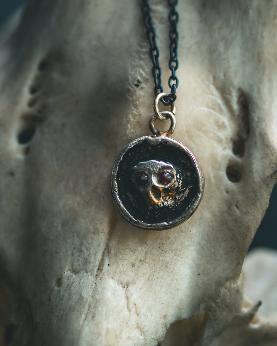 Memento Mori Skull Charm with Almandine Garnet Eyes Sterling Silver & 23.5K Gold | Talisman of Life, Death, and Deep Transformation - Machinations