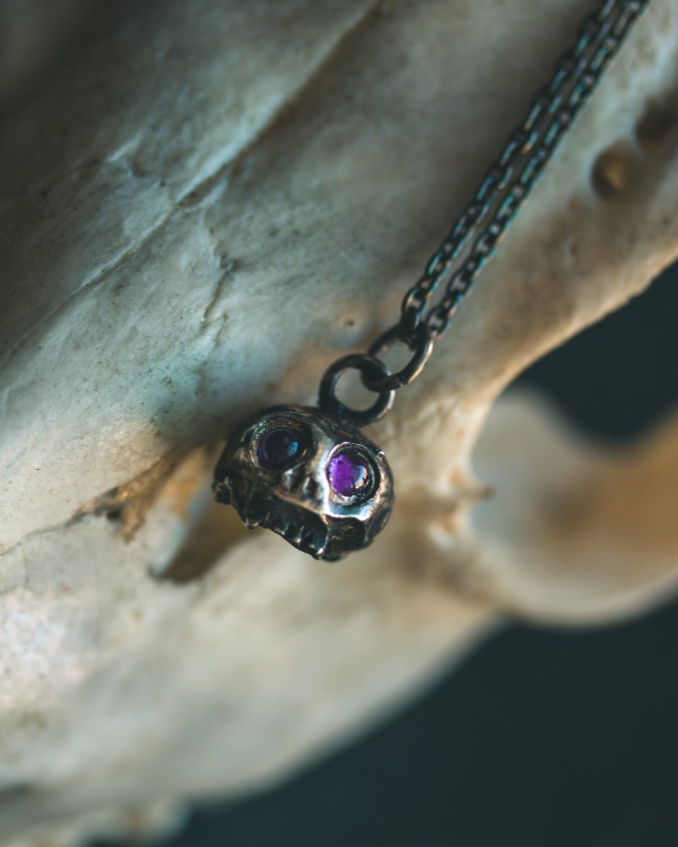 Memento Mori Skull Charm with Amethyst Eyes: A Reflection of Life’s Duality - Machinations