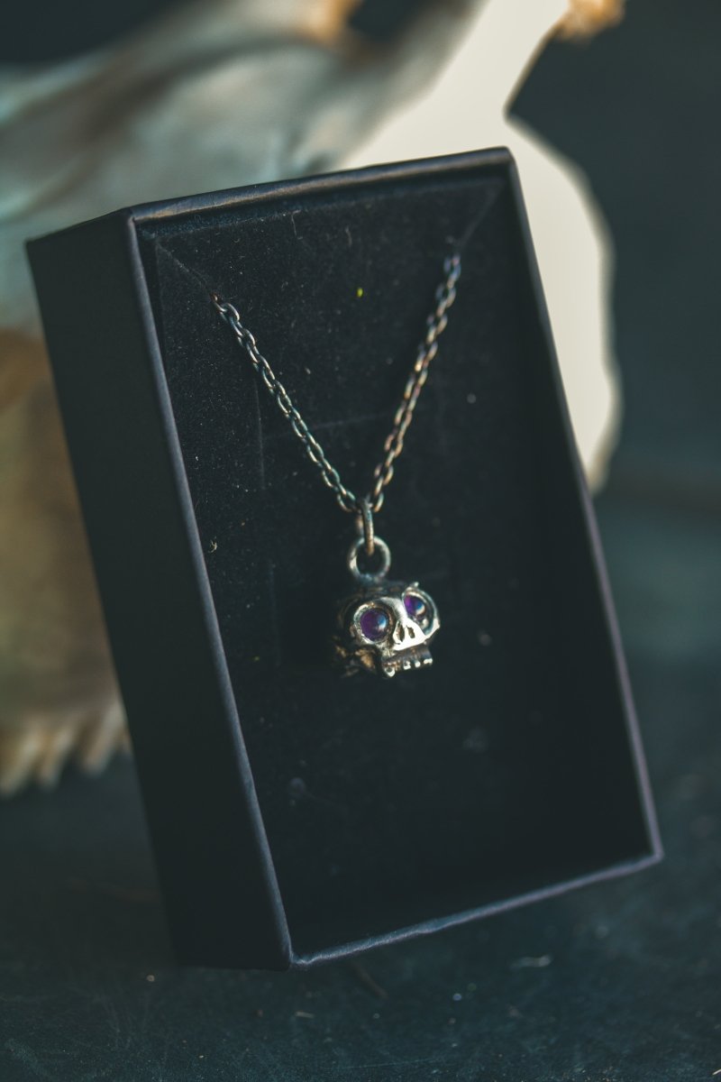 Memento Mori Skull Charm with Amethyst Eyes: A Reflection of Life’s Duality - Machinations