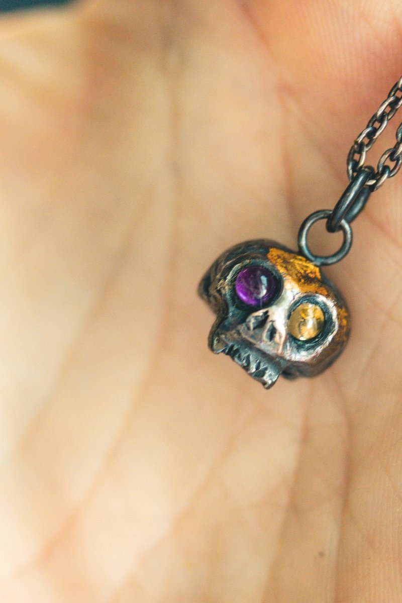 Memento Mori Skull Charm with Peridot and Amethyst Eyes: A Tribute to Life’s Duality and the Spirit of Beetlejuice (Limited Edition) - Machinations