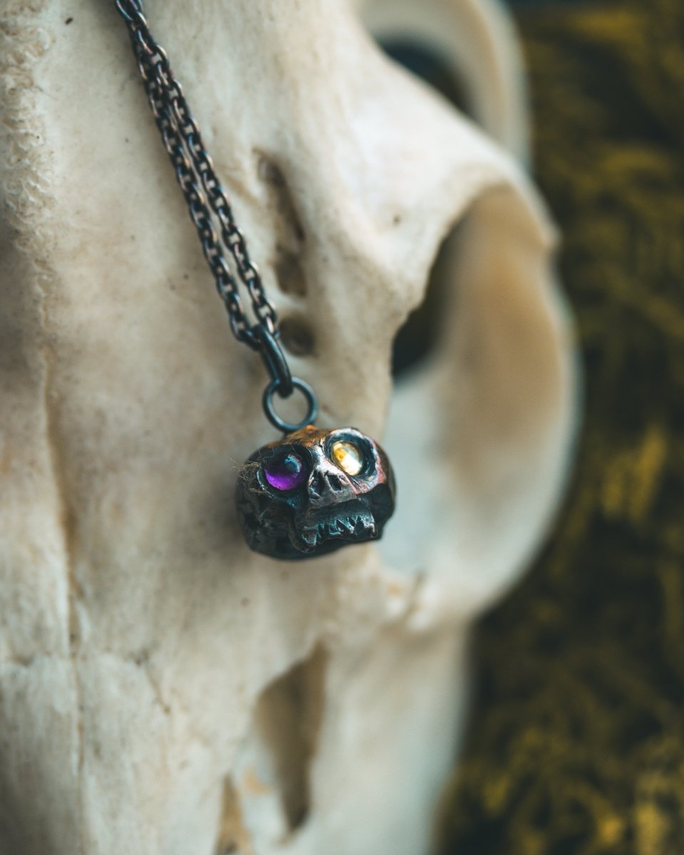 Memento Mori Skull Charm with Peridot and Amethyst Eyes: A Tribute to Life’s Duality and the Spirit of Beetlejuice (Limited Edition) - Machinations