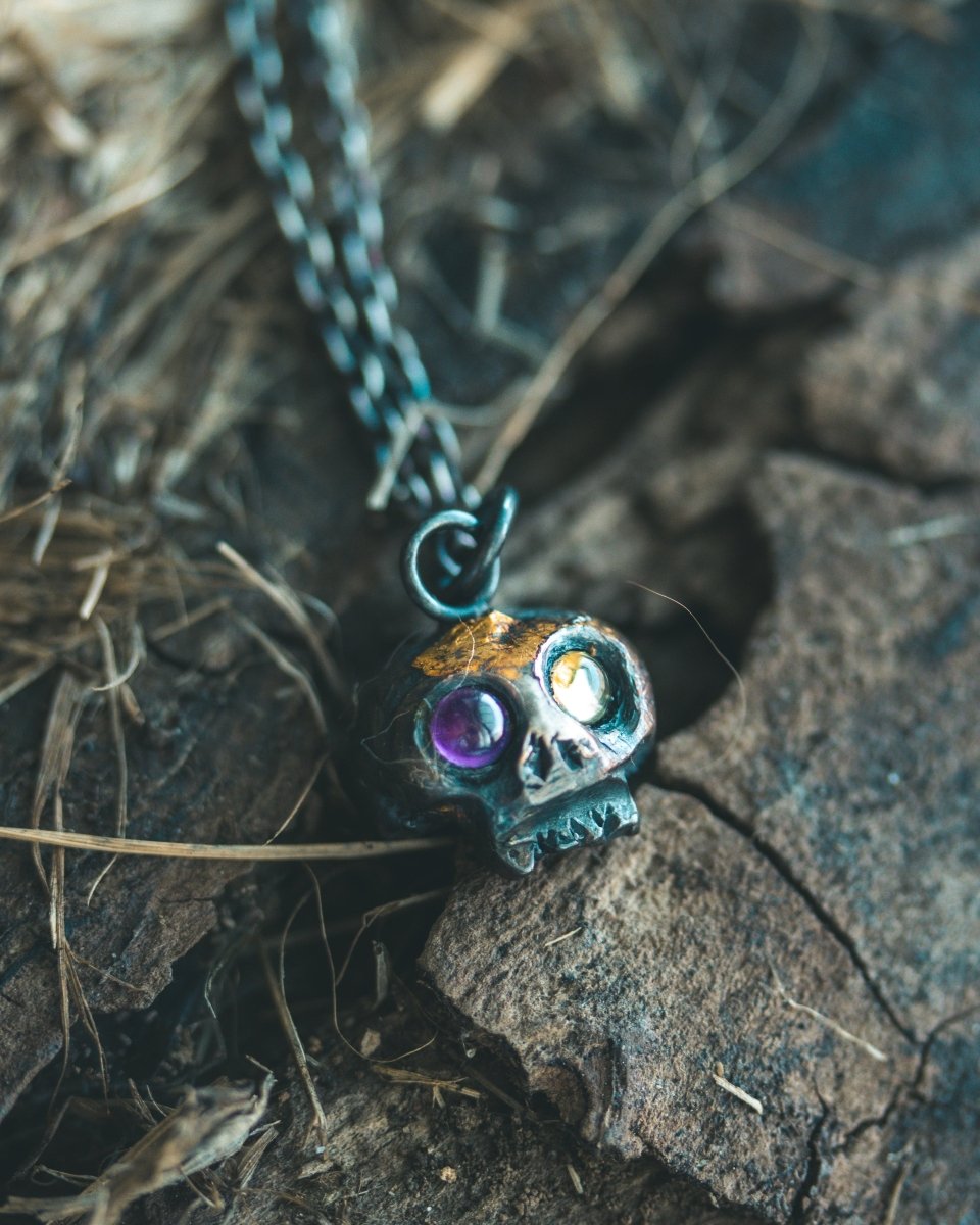 Memento Mori Skull Charm with Peridot and Amethyst Eyes: A Tribute to Life’s Duality and the Spirit of Beetlejuice (Limited Edition) - Machinations