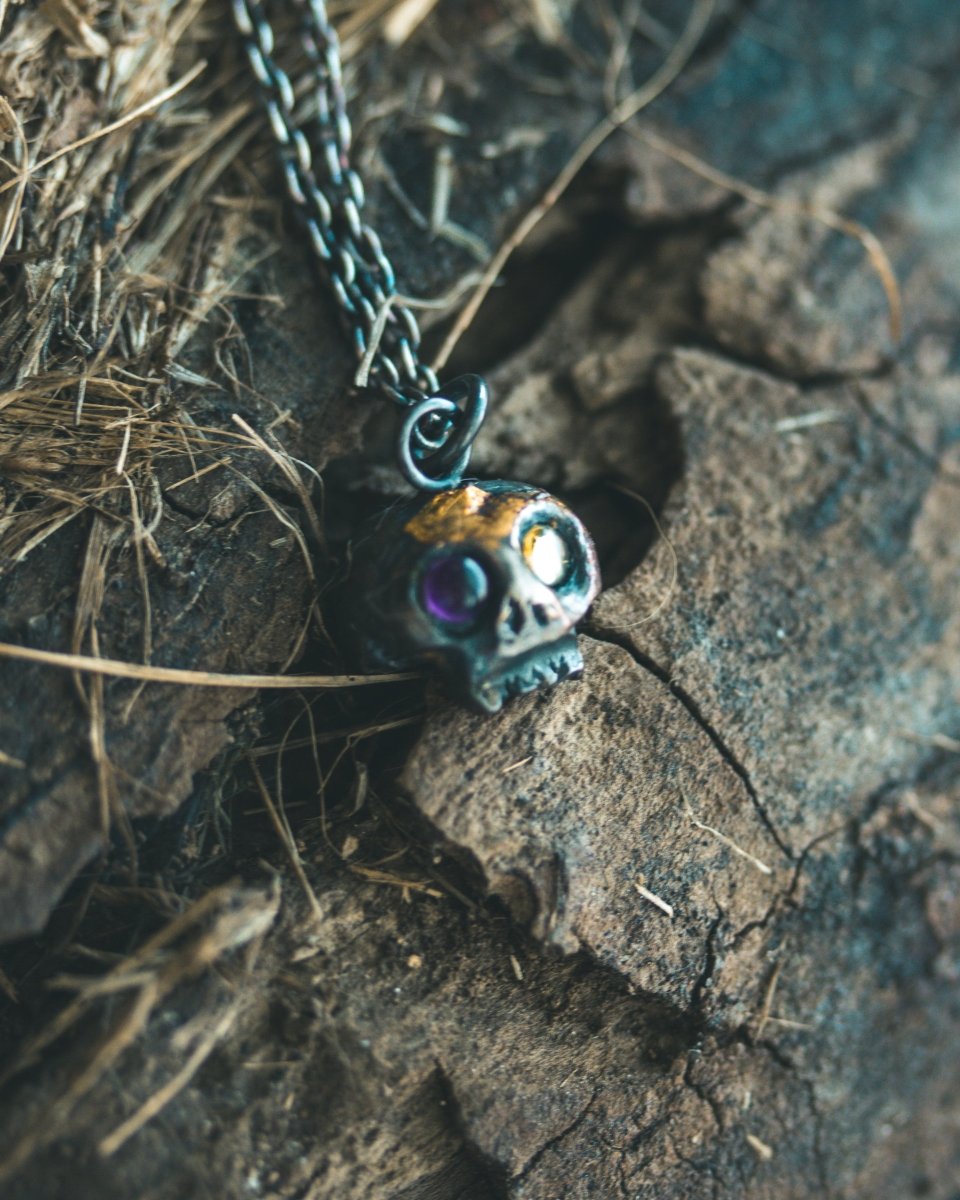 Memento Mori Skull Charm with Peridot and Amethyst Eyes: A Tribute to Life’s Duality and the Spirit of Beetlejuice (Limited Edition) - Machinations