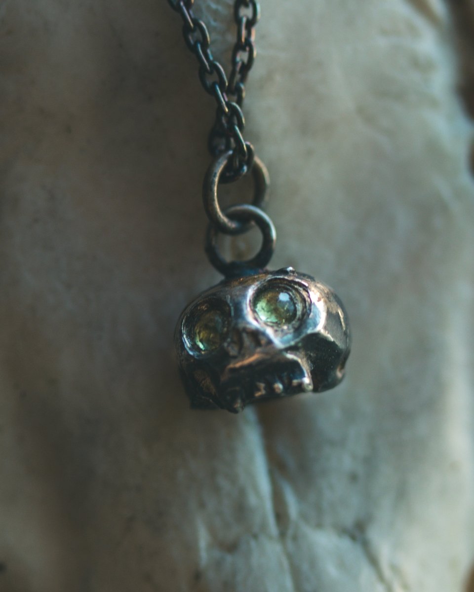 Memento Mori Skull Charm with Peridot Eyes: A Reflection of Life’s Duality - Machinations