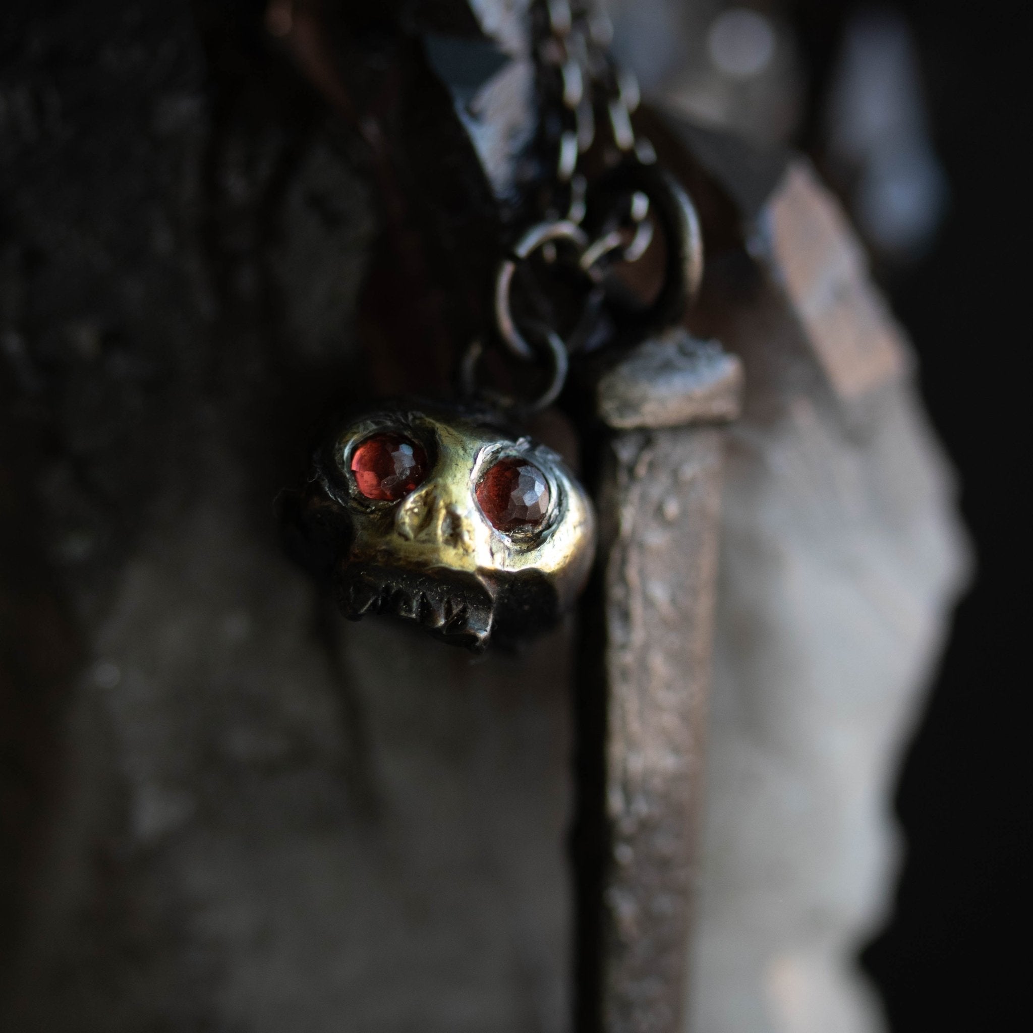 Skull charm with garnet eyes - Machinations