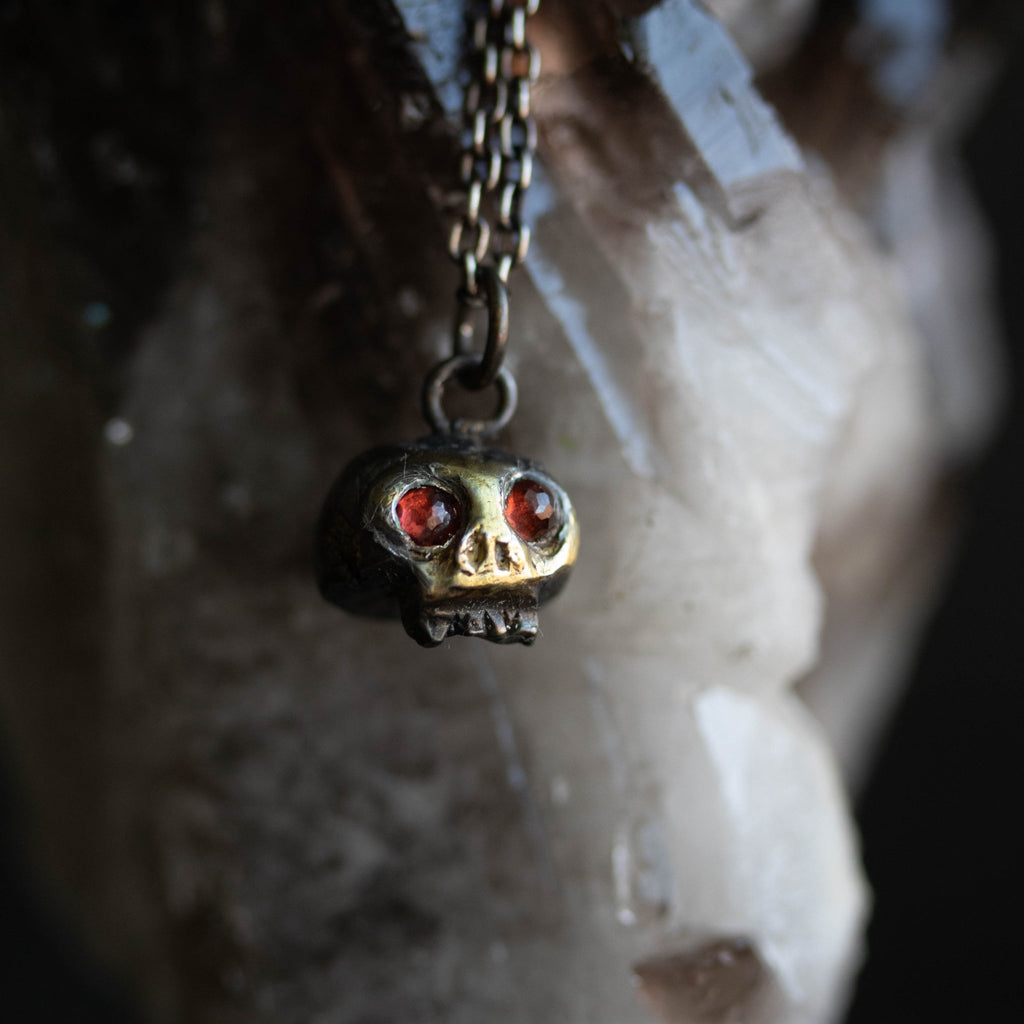 Skull charm with garnet eyes - Machinations