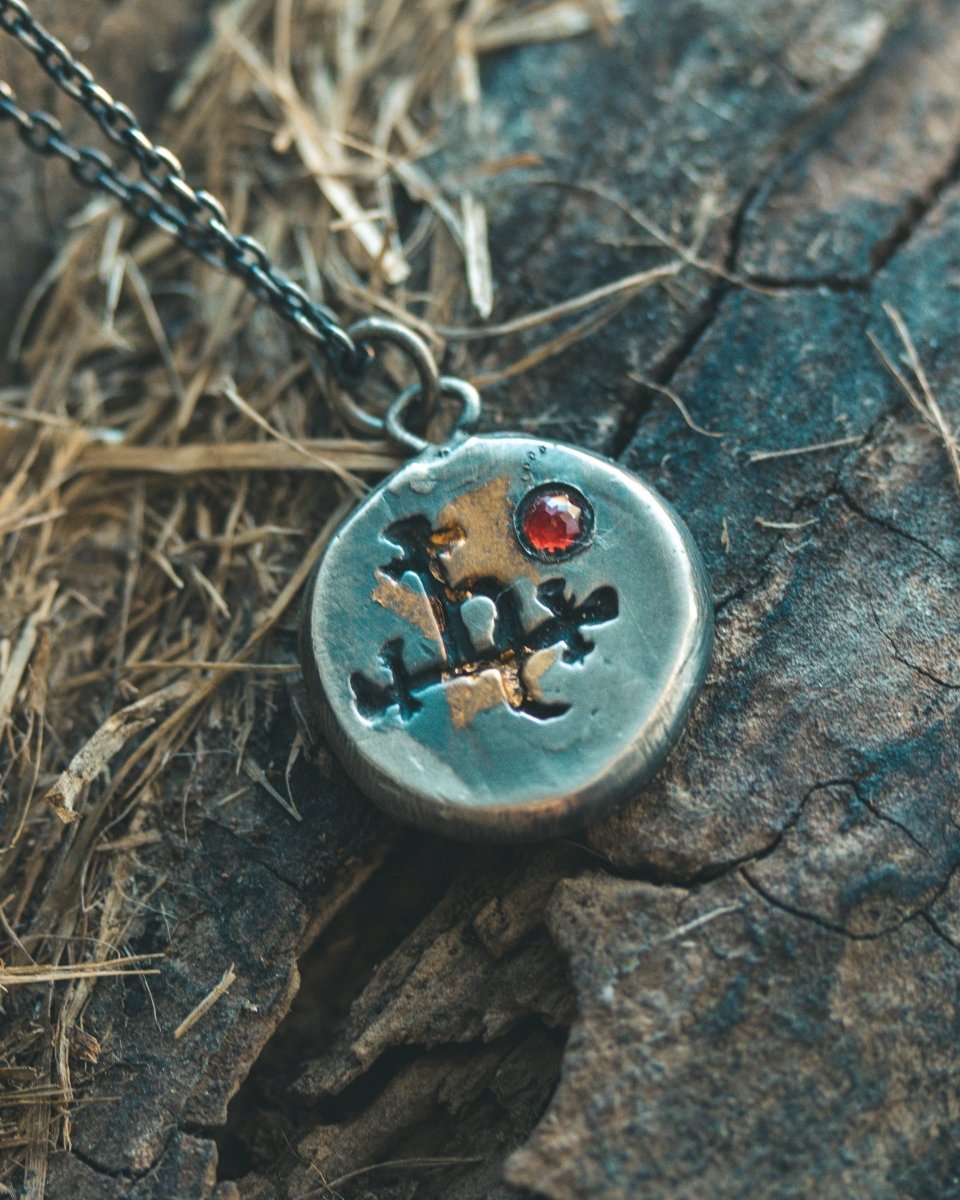 The Lilith Charm with Almandine Garnet: A Talisman of Empowerment in Sterling Silver and Gold - Machinations